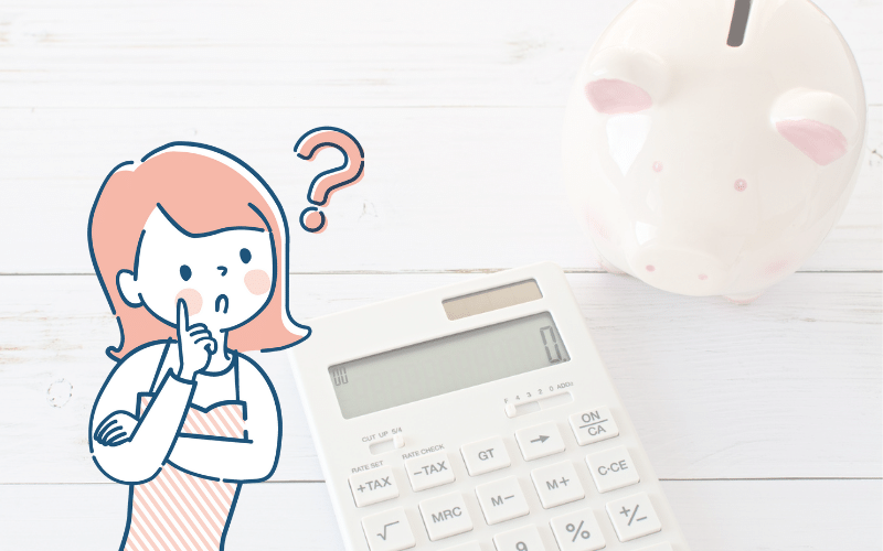 計算機と貯金箱と疑問がある女性